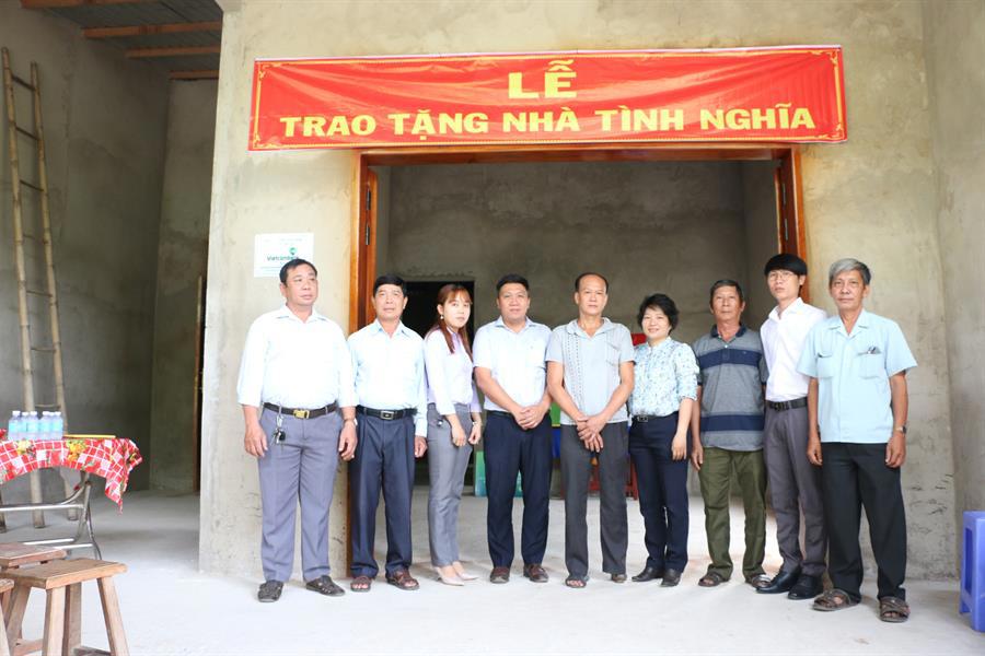 Đại diện Vietcombank Tiền Giang (thứ 4 từ trái sang) cùng chính quyền địa phương chụp hình lưu niệm với ông Nguyễn Văn Vũ tại căn nhà vừa được bàn giao