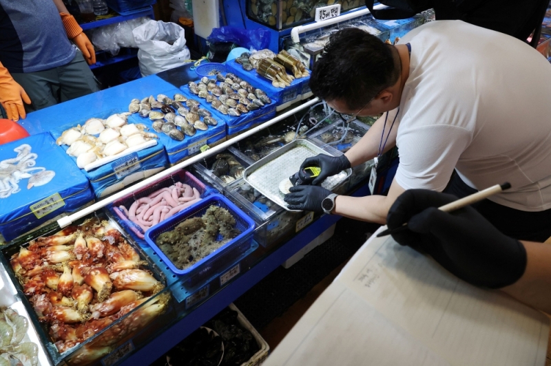 S&ograve; điệp nhập khẩu từ Nhật Bản được đo nồng độ ph&oacute;ng xạ tại chợ hải sản Noryangjin ở Seoul, H&agrave;n Quốc hồi th&aacute;ng 7/2023. (Ảnh: Reuters).