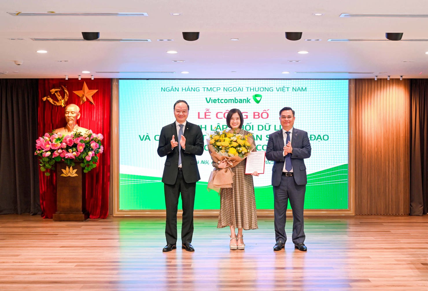 Ông Nguyễn Thanh Tùng trao Quyết định và ông Lê Quang Vinh tặng hoa chúc mừng bà Phùng Nguyễn Hải Yến - Phó Tổng Giám đốc, tân Giám đốc Khối Dữ liệu.