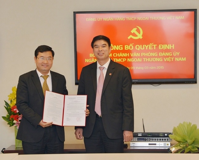 Ông Vũ Tiến Duật - Phó Bí thư thường trực Đảng ủy (bên phải) trao quyết định cho ông Nguyễn Ngọc Dũng - tân Chánh Văn phòng Đảng ủy Vietcombank