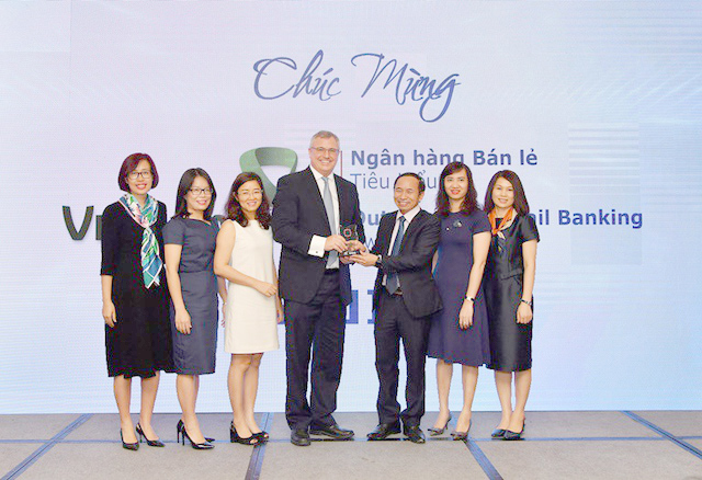 Ông Thomas William Tobin – Giám đốc Khối bán lẻ (thứ 4 từ trái sang) và đại diện các phòng/ban/trung tâm thuộc Khối bán lẻ Vietcombank nhận Giải thưởng “Ngân hàng bán lẻ tiêu biểu” năm 2018.
