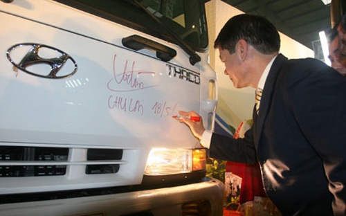Người đứng đầu Thaco Group, ông Trần Bá Dương ký tên vào cabin một xe tải Hyundai do Thaco lắp ráp. Nguồn: vneconomy.vn