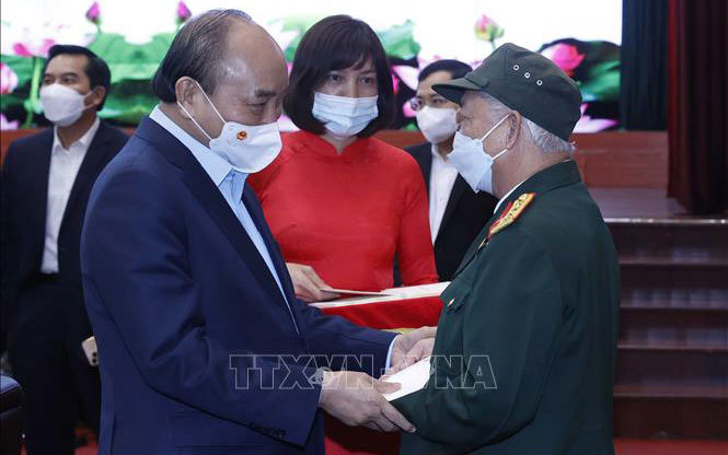 Chủ tịch nước Nguyễn Xuân Phúc tặng quà Tết cho các đối tượng chính sách. Ảnh: TTXVN