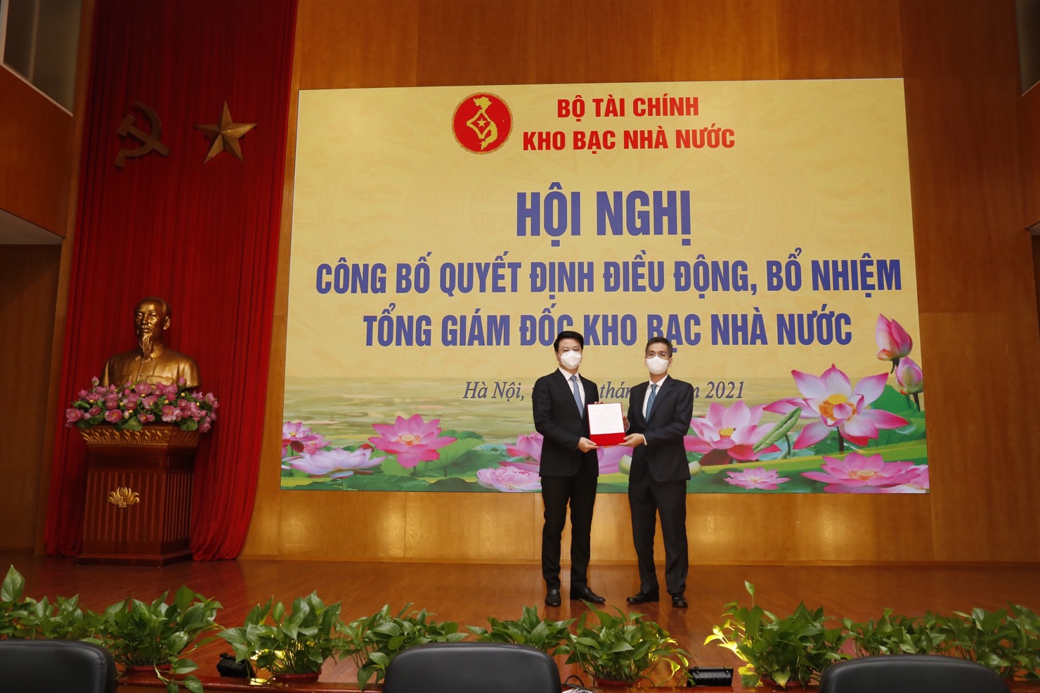 Thứ trưởng Bộ Tài chính Võ Thành Hưng (bên phải) trao quyết định điều động, bổ nhiệm cho tân Tổng giám đốc KBNN Trần Quân. Nguồn: KBNN