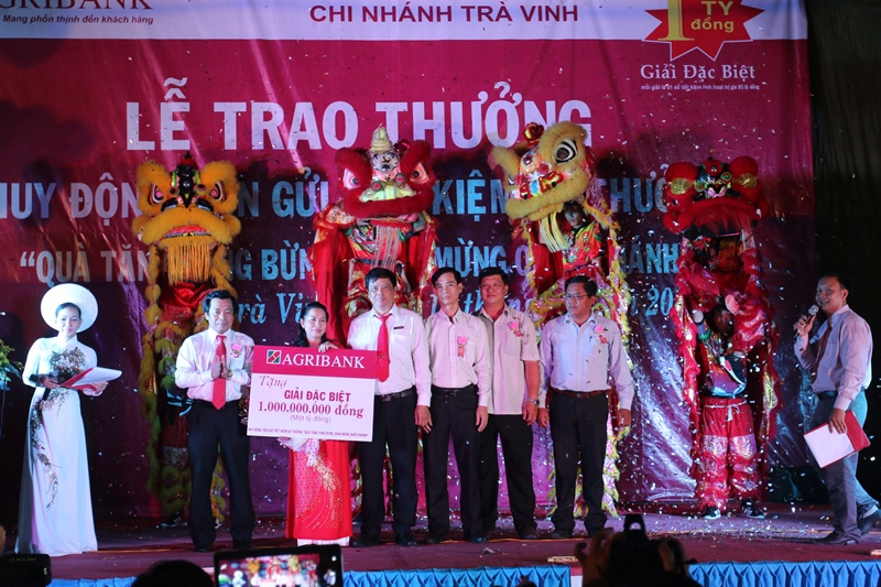 Ông Trần Ngọc Tồn, Trưởng Văn phòng đại diện Agribank khu vực Tây Nam bộ (thứ 2 từ trái sang) trao giải thưởng 01 tỷ đồng cho khách hàng trúng thưởng.