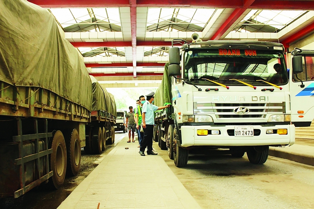 Công chức Chi cục Hải quan cửa khẩu Cha Lo, Cục Hải quan Quảng Bình phối hợp thực hiện giám sát phương tiện vận tải hàng hóa XNK qua địa bàn . Ảnh: Q.H